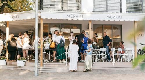 a group of people standing outside of a restaurant at Concord Apartment in Stellenbosch