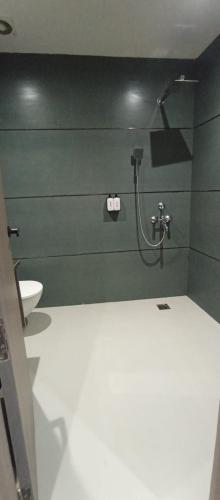 a bathroom with a shower and a toilet at AairHotel in Karnal