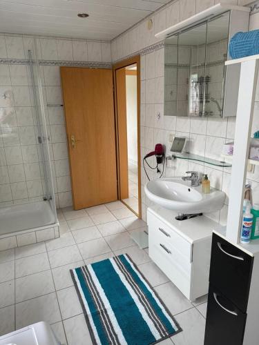 a bathroom with a sink and a toilet and a shower at Selina's Apartment in Oberthal