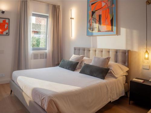 a bedroom with a large white bed with two pillows at Tenuta Asmara Luxury Resort in San Miniato
