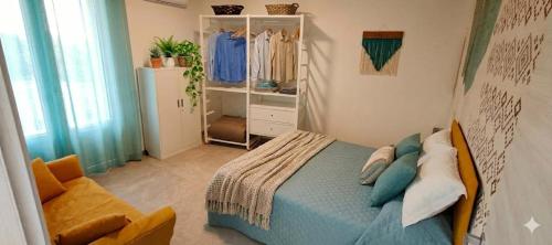 a small bedroom with a bed and a chair at Casa Via Marconi in Assemini