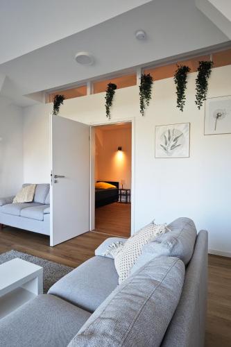 a living room with a couch and a bedroom at Pelster´s Apartments in Diepholz