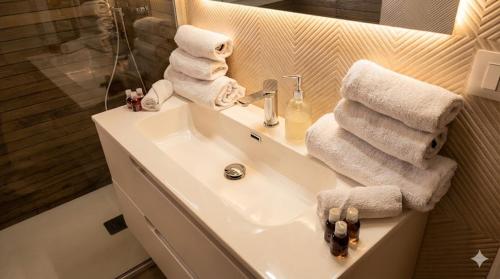 a bathroom with a sink with towels on it at Casa Via Marconi in Assemini
