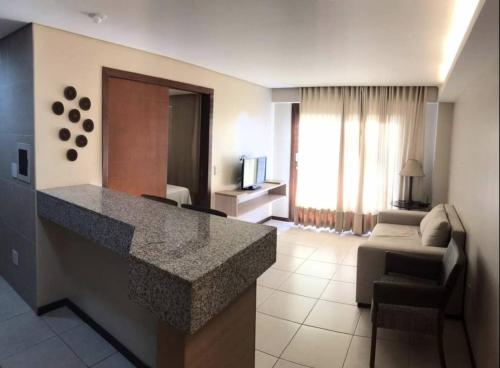 a hotel room with a kitchen and a living room at Beach Front Apartment Kariri in Caucaia