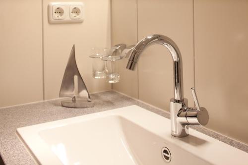 a bathroom sink with a chrome faucet at Inselhotel Langeoog in Langeoog