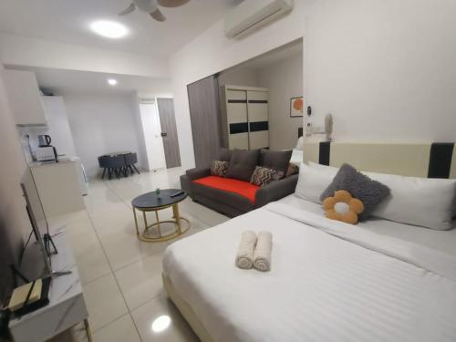 a bedroom with a large white bed and a couch at Continew Residence by TM House in Kuala Lumpur