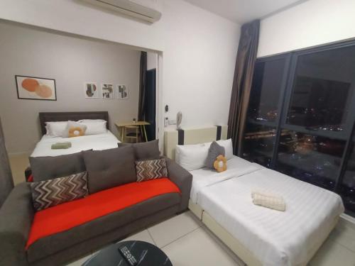 a living room with a couch and a bed and a window at Continew Residence by TM House in Kuala Lumpur