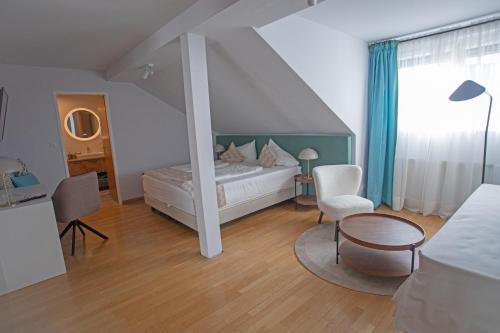 a bedroom with a bed and a table and chairs at Frühstückspension Josefinum in Bad Aussee