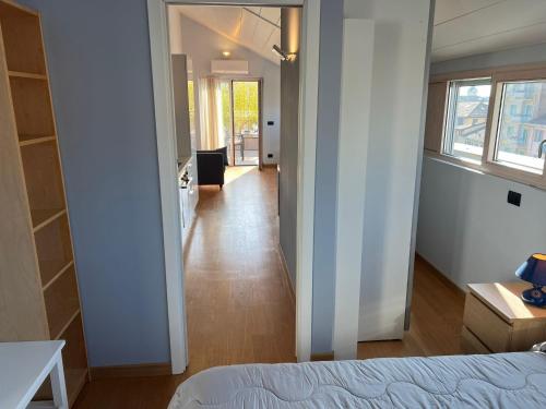 a bedroom with a bed and a hallway at Attico Don Minzoni in Intra