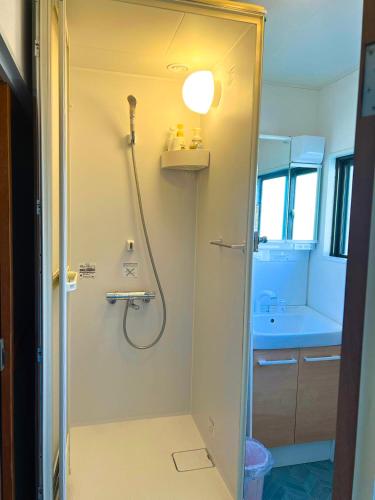 a bathroom with a shower and a sink at 媛楽園Himerakuen in Matsuyama