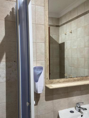a bathroom with a soap dispenser next to a sink at Hotel Center 2 in Rome