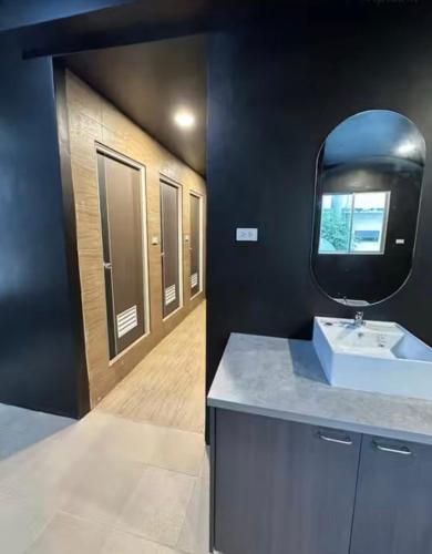a bathroom with a sink and a mirror at HOOD Hostel Jomtien in Jomtien Beach