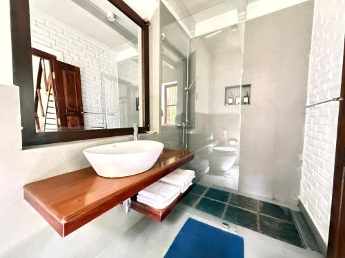 a bathroom with a sink and a mirror at Villa Kobeimalhena, Matara in Matara