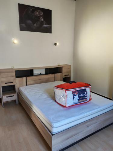 a bed in a room with a bed frame at Les Nids Pyrénéens in Castillon-de-Larboust