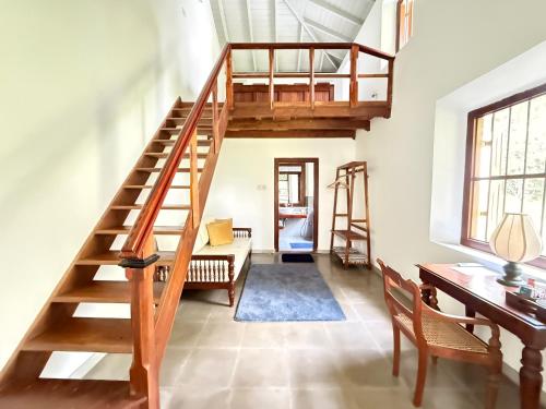 a living room with a wooden staircase and a desk at Villa Kobeimalhena, Matara in Matara