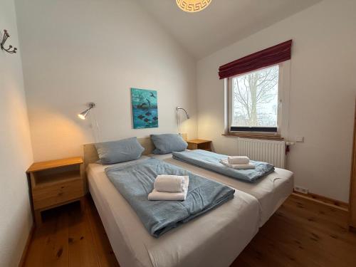 a bedroom with a bed with two pillows on it at Seeschwalbe in Munkbrarup