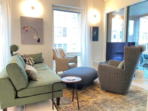 a living room with a couch and two chairs at Luxury City Seafront Apartment with Balcony in Helsinki