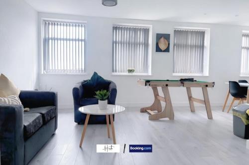 a living room with a couch and a table at Luxury two bedroom apartment with parking games and fast unlimited Wi-Fi by Hush Haven Homes Serviced Accommodation in Hull