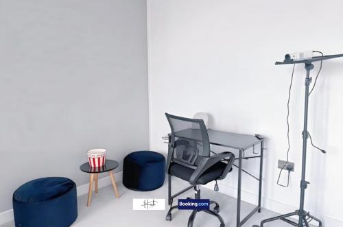 a room with a chair and a desk and stool at Luxury two bedroom apartment with parking games and fast unlimited Wi-Fi by Hush Haven Homes Serviced Accommodation in Hull
