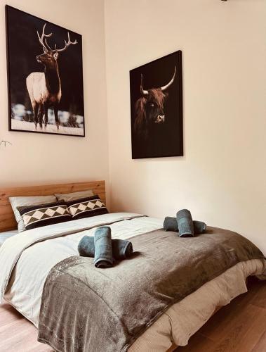 a bedroom with a bed and a picture of a bull at TINY HOUSE - La cabane de Tom in Blaimont