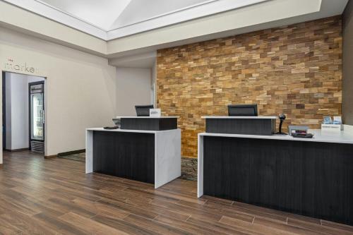 an office with reception desks and a brick wall at Residence Inn Paducah in Paducah