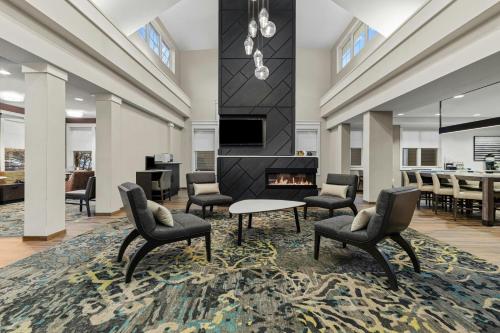 a living room with chairs and a fireplace at Residence Inn Paducah in Paducah