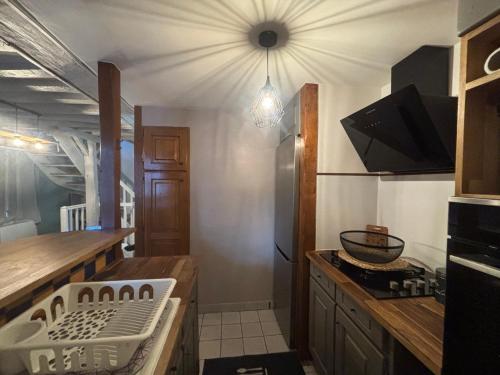 a kitchen with a sink and a stove top oven at Maison in Verneuil-en-Halatte