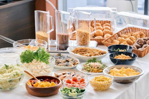 a buffet with many different dishes of food on a table at Urbain Hiroshima Central in Hiroshima