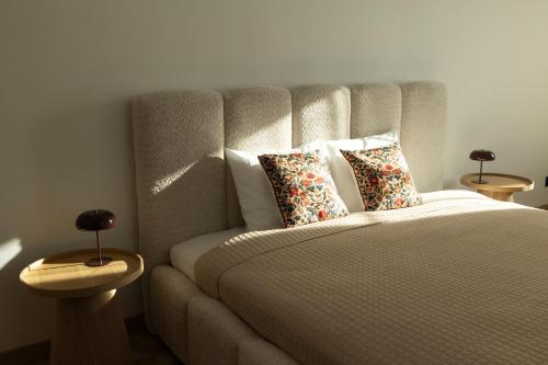 a bedroom with a bed with pillows on it at ATRIUM City Center Apartment in Kaunas