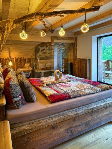 a bedroom with a large bed in a room at Bergromantik Ferienwohnung Charisma mit eigener Sauna, Whirlpool und Bergblick in Marktschellenberg