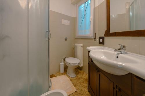 a bathroom with a sink and a toilet at House Carla in Bellano