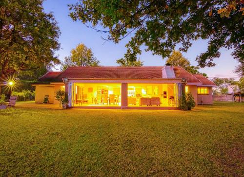 a home with a large yard with a house at Riverside Rhapsody, Vaal River, Vanderbijlpark, 6 Adults and 4 Children in Vanderbijlpark