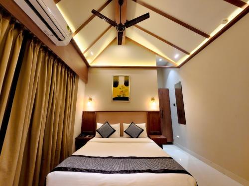 a bedroom with a bed and a ceiling at The Falcon Inn - Clare Road in Mumbai