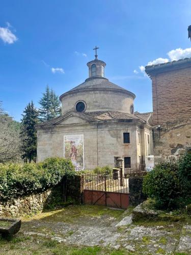 an old building with a cross on top of it at Gredos Abantera in Arenas de San Pedro