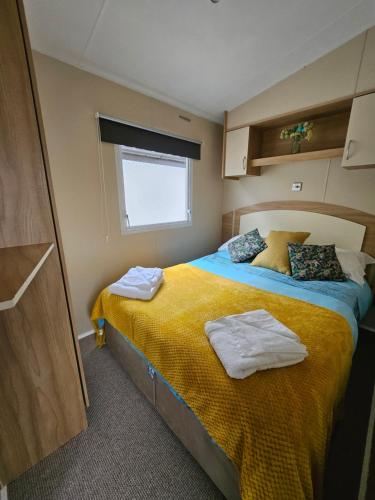 a bedroom with a bed with towels on it at Ruth's Rest Shropshire Country Retreat with private Hot Tub & Views countryside in Shrewsbury