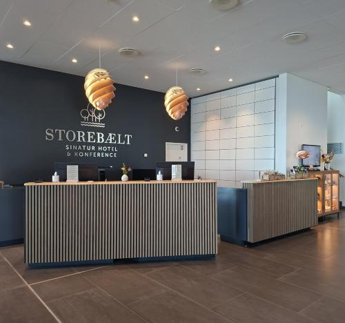 a lobby of a store with a sign on the wall at Storebælt Sinatur Hotel & Konference in Nyborg