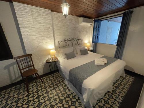 a bedroom with a large bed and a window at Pousada Beija Flor in Salvador