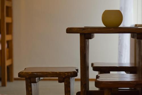 a table and two stools with a bowl on top at Mileżówka - Noclegi&SPA in Ustroń