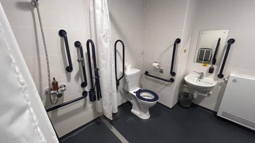 a bathroom with a toilet and a sink at Sunley Hotel in Northampton
