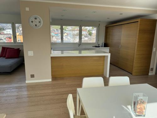 a kitchen and living room with a table and a clock at Rotonda in Gordola