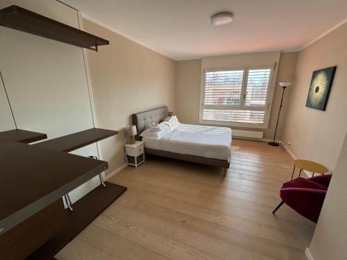 a bedroom with a bed and a large window at Rotonda in Gordola