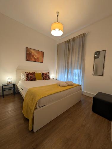 a bedroom with a large bed and a window at Beautiful Infante Apartment in Porto