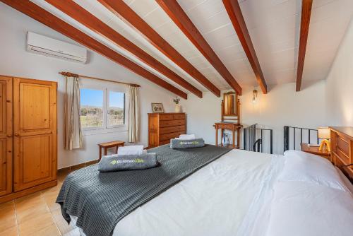 a bedroom with a large bed and a window at Villa Can Deyá in Port de Pollensa