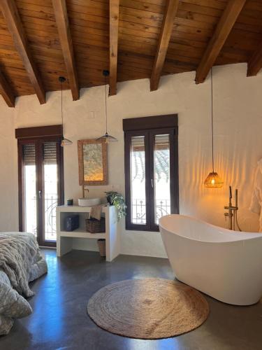 a large bathroom with a tub in a room at ruralhome sanroque in Altura