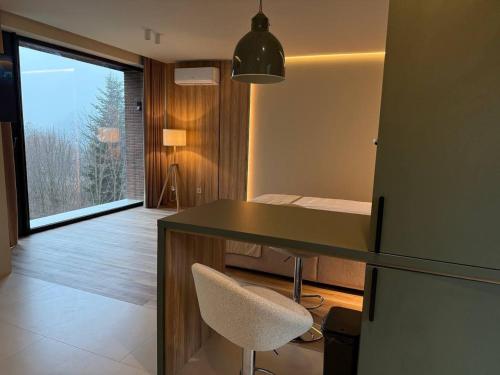 a room with a desk and a chair and a window at Travy in Yaremche