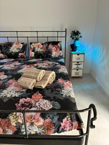 a bedroom with a bed with a floral bedspread at 33 Joy Dreams in Sandra