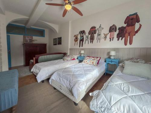 a bedroom with two beds and a ceiling fan at Casa Laura in Modigliana