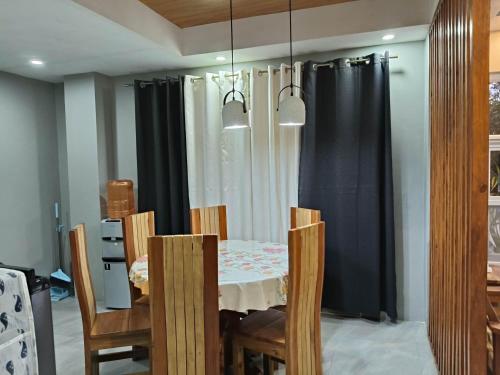 a dining room with a table and chairs at MEEK'S VILLAS TRANSIENT HOUSE in Baguio