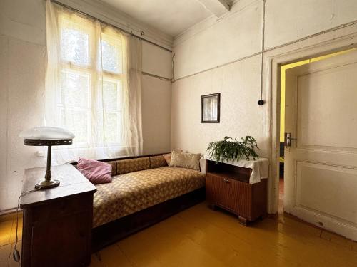 a living room with a couch and a window at Rozulas skola in Rozula