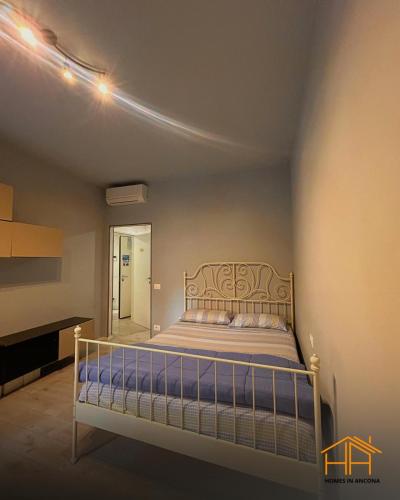 a bedroom with a bed and a mirror at CarloAlberto23- Rooms by Homes in Ancona in Ancona